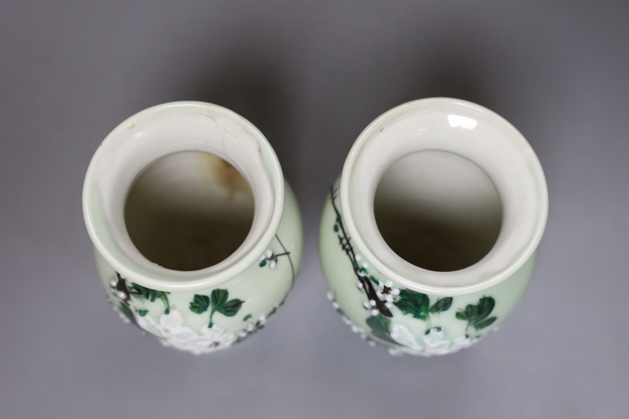 Three Chinese famille rose celadon ground plates and a pair of Japanese celadon ground vases